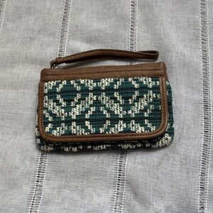 Cape Juby geometric print wristlet clutch with a brown leather-look trim.